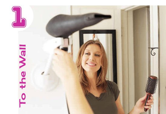 A woman using a hands free blow dryer holder